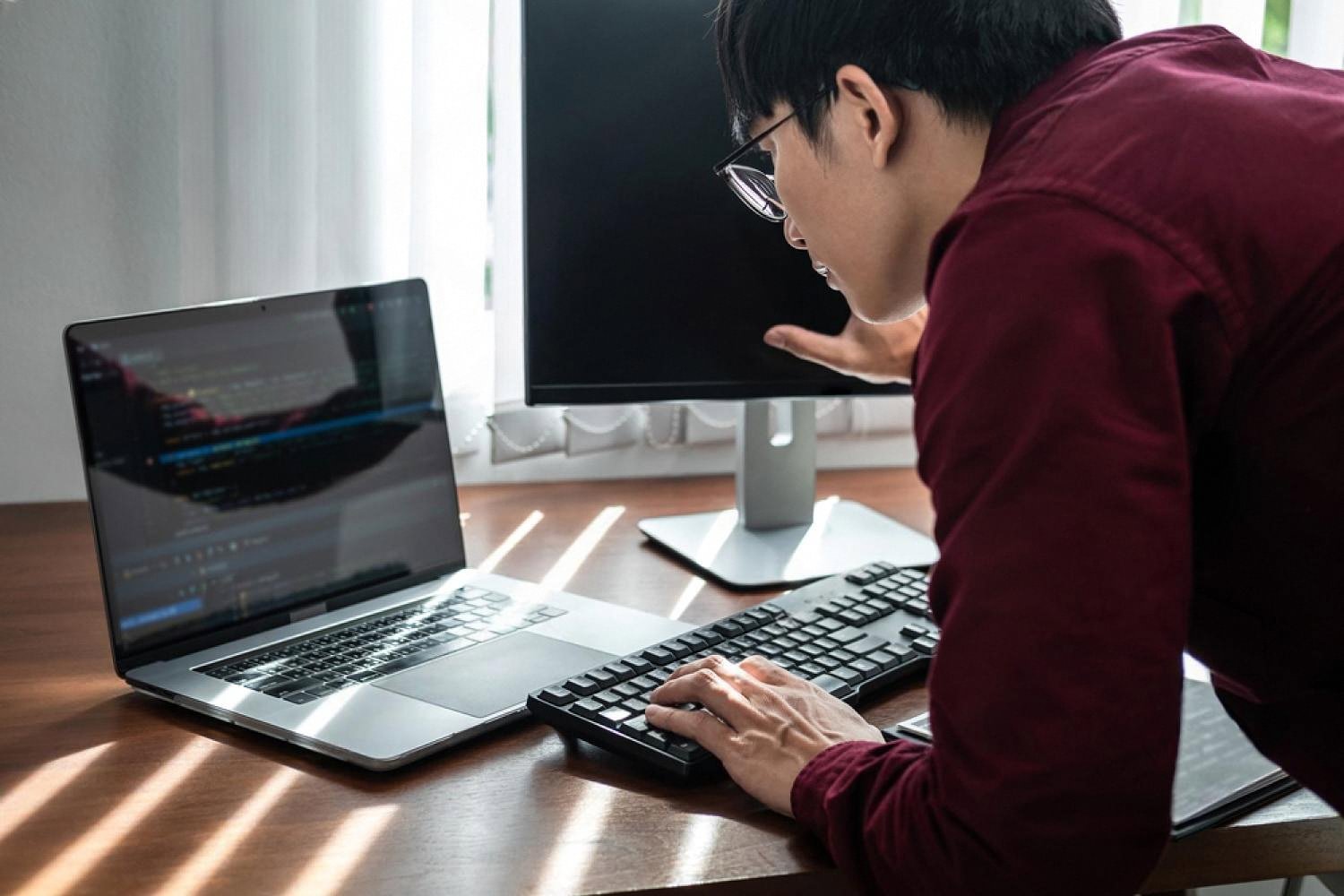 UAE office employee reviewing code on a laptop during a corporate security training session